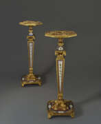 Floor lights. A PAIR OF RESTAURATION ORMOLU AND PARIS PORCELAIN-MOUNTED AMARANTH AND MAHOGANY TORCHERES