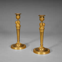 A PAIR OF CONSULAT ORMOLU CANDLESTICKS