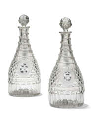 A PAIR OF ENGLISH CUT-GLASS ARMORIAL PINT DECANTERS AND STOPPERS