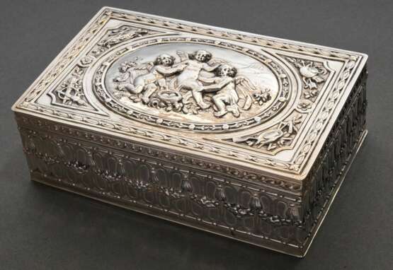 Rechteckiger Kasten im Louis XVI Stil mit Scharnierdeckel und getriebenem "Putten" Dekor auf der Wandung, um 1900, Grosse & Eckert/ Berlin, Silber 800 innen vergoldet, 296g, 4,5x14x9cm - фото 1