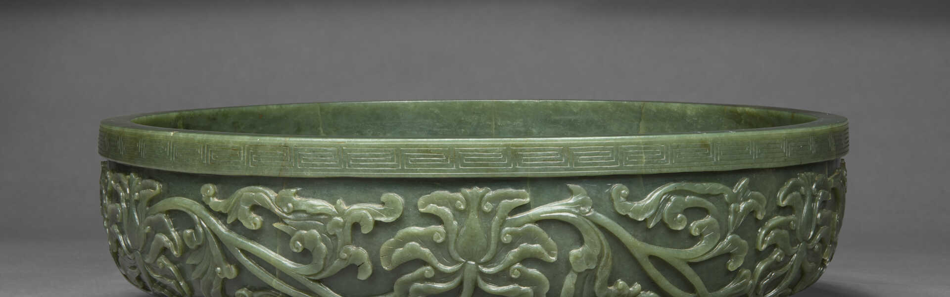 A MASSIVE AND VERY RARE CARVED SPINACH-GREEN JADE SHALLOW BASIN