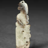 A PALE GREYISH-BEIGE AND BROWN JADE PENDANT - фото 1