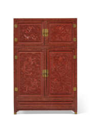 A VERY RARE LARGE CARVED RED LACQUER KANG CABINET