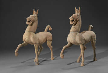 A PAIR OF LARGE PAINTED POTTERY FIGURES OF PRANCING HORSES