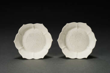 A RARE PAIR OF SMALL MOLDED WHITE-GLAZED ‘LOTUS’ DISHES