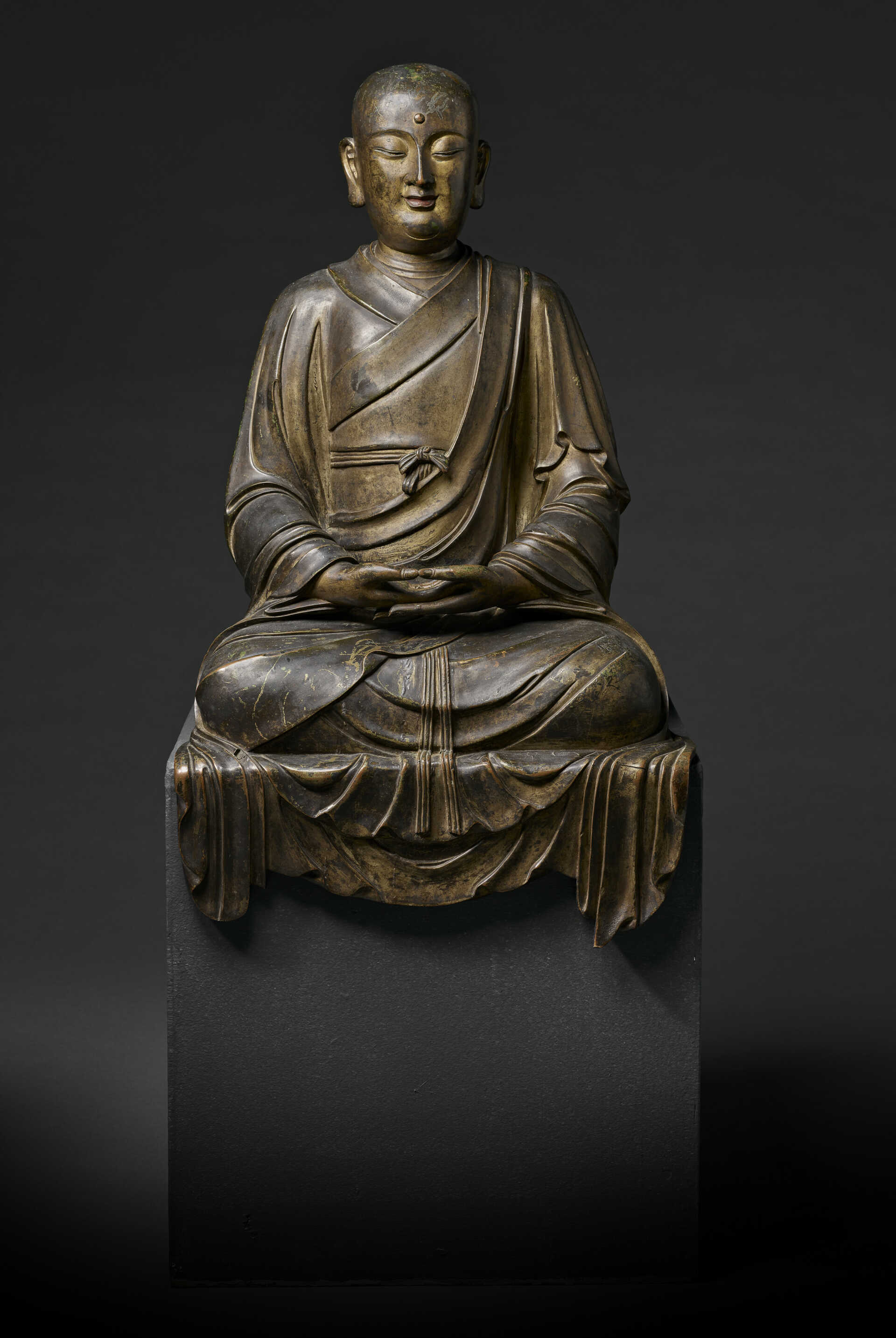 A VERY RARE AND LARGE GILT-BRONZE FIGURE OF A SEATED LUOHAN