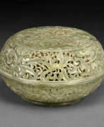 Ikone. A WELL-CARVED PALE GREY-GREEN JADE RETICULATED PARFUMIER AND COVER