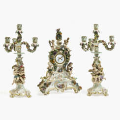 A three-piece mantlepiece set - magnificent pendulum clock on a pedestal and a pair of four-light girandoles. Meissen