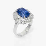 An entourage ring with a sapphire and diamonds. - photo 1