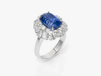 An entourage ring with a sapphire and diamonds.