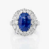 An entourage ring with a sapphire and diamonds. - photo 2