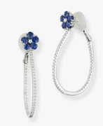 Украшения для ушей. A pair of hoop earrings decorated with blue sapphires and brilliant-cut diamonds. Germany