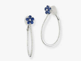 A pair of hoop earrings decorated with blue sapphires and brilliant-cut diamonds. Germany