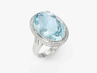 An entourage ring decorated with a fine, bright, large aquamarine and brilliant-cut diamonds. Germany