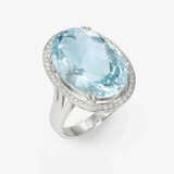 An entourage ring decorated with a fine, bright, large aquamarine and brilliant-cut diamonds. Germany - фото 1