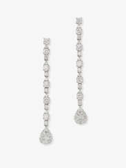 A pair of delicate, long drop earrings decorated with diamonds in different cuts. Germany