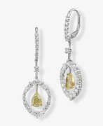 Ear Jewelry. A pair of diamond drop earrings.