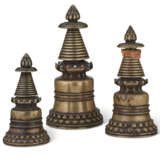 A GROUP OF THREE BRONZE KADAMPA STUPAS - photo 2