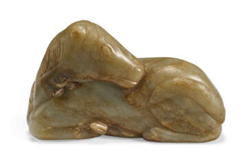 A PALE GREYISH-GREEN AND RUSSET JADE FIGURE OF A RECUMBENT HORSE 