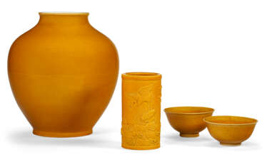 A GROUP OF FOUR YELLOW-GLAZED VESSELS
