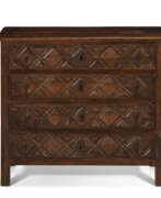 Nussbaum. A SPANISH OAK AND WALNUT CHEST-OF-DRAWERS