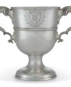 Cups. A GEORGE III IRISH SILVER TWO-HANDLED CUP