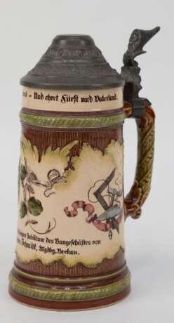 Bierkrug mit Zinndeckel, Mettlach Nr. 4184 mit Schloßmarke, "Andenken zum 50jährigen Jubiläum des Baugeschäftes..", mit Darstellung von Werkzeugen der Zimmerer und Maurer, Zinndeckel mit Zwergenkopf als Daumend… - фото 1