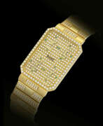 Piaget. PIAGET, GOLD AND DIAMOND-SET FOUR TIME ZONE BRACELET WATCH