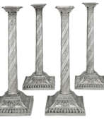 England. A SET OF FOUR GEORGE III SILVER CANDLESTICKS