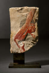 AN EGYPTIAN PAINTED LIMESTONE RELIEF FRAGMENT