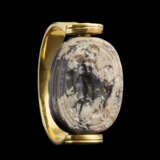 AN ETRUSCAN CALCIFIED GRAY JASPER SCARAB WITH A NUDE YOUTH AND A DOG - photo 1