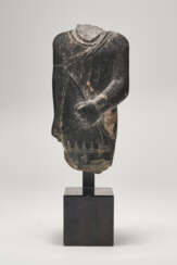 AN EGYPTIAN GRANODIORITE TORSO OF A STRIDING OFFICIAL