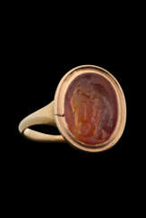 A ROMAN CARNELIAN RINGSTONE WITH AN OLD MAN AND A SKULL