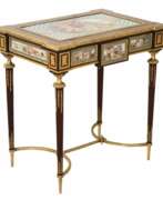 Tables. A magnificent ladies table with gilded bronze decor and porcelain panels in the style of Adam Weisweiler. France. 19th century