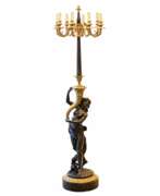 Floor lights. French floor lamp made of gilded and patinated bronze. The turn of the 19th and 20th centuries.