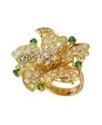 Rings. Gold 18K ring with seventy-seven diamonds and five emeralds.