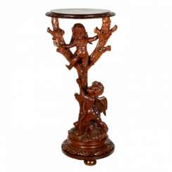 Wooden console with carved cupids.
