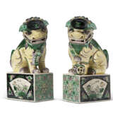 A PAIR OF CHINESE EXPORT PORCELAIN BUDDHISTIC LIONS ON STANDS - фото 1