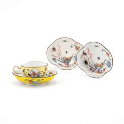 Meissen. A PORCELAIN CUP AND THREE SAUCERS WITH YELLOW GROUND AND BIRD AND ROCK DECORATION