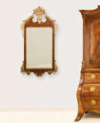 Furniture. Empire mirror with crowning and brass chandeliers