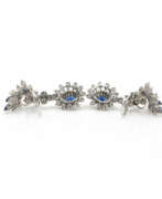 Overview. Pair of clip earrings set with sapphires and diamonds
