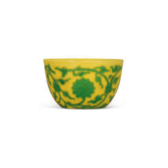 A FINE AND EXTREMELY RARE CARVED YELLOW-GROUND GREEN-ENAMELLED ‘LOTUS’ WINE CUP