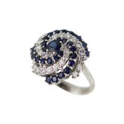 Spiral-shaped gold ring with sapphires and diamonds.