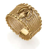 Yellow gold openwork bangle bracelet with centerpiece accented with mask, g 70.23 circa, h cm 4.0, diam. cm 6.0 circa circa. - photo 1