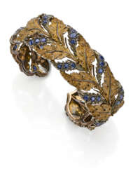 BUCCELLATI | Sapphire, gold and silver leaf shaped bangle bracelet, g 52.83 circa, diam. cm 6 circa. Signed Buccellati, 750. (slight defects)