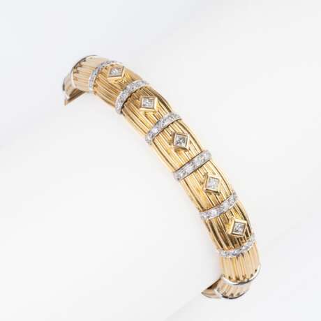 A Gold Bangle Bracelet with Diamonds. - photo 1