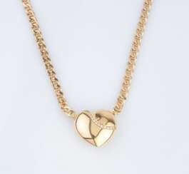 A Gold Necklace with heartshaped Diamond Clasp.