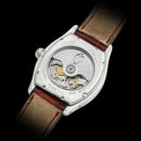 CARTIER. A RARE 18K WHITE GOLD TONNEAU-SHAPED AUTOMATIC PERPETUAL CALENDAR WRISTWATCHWITH LEAP YEAR INDICATION - photo 2