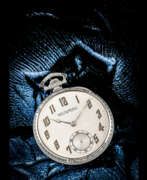 Overview. PATEK PHILIPPE. AN 18K WHITE GOLD OPEN FACE POCKET WATCH WITH “ART DECO” ENGRAVINGS