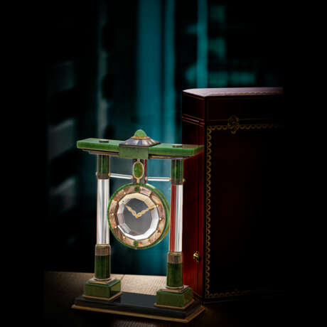 CARTIER. A MAGNIFICENT AND EXTREMELY RARE SILVER AND NEPHRITE-SET MYSTERY CLOCK WITH MOTHER OF PEARL, EMERALD, CHALCEDONY, ROCK CRYSTAL, AND DIAMONDS - фото 1